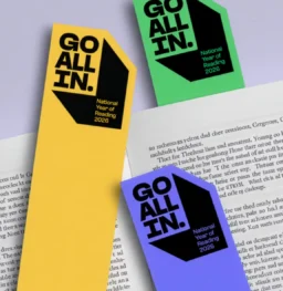 “Go All In” bookmarks placed inside a book