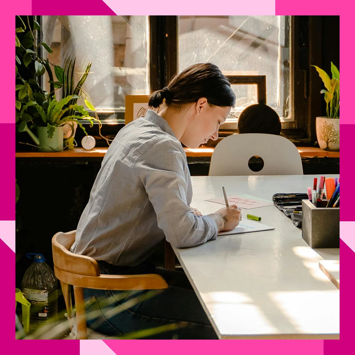 Lady seated at a table and working or reading in a shared space