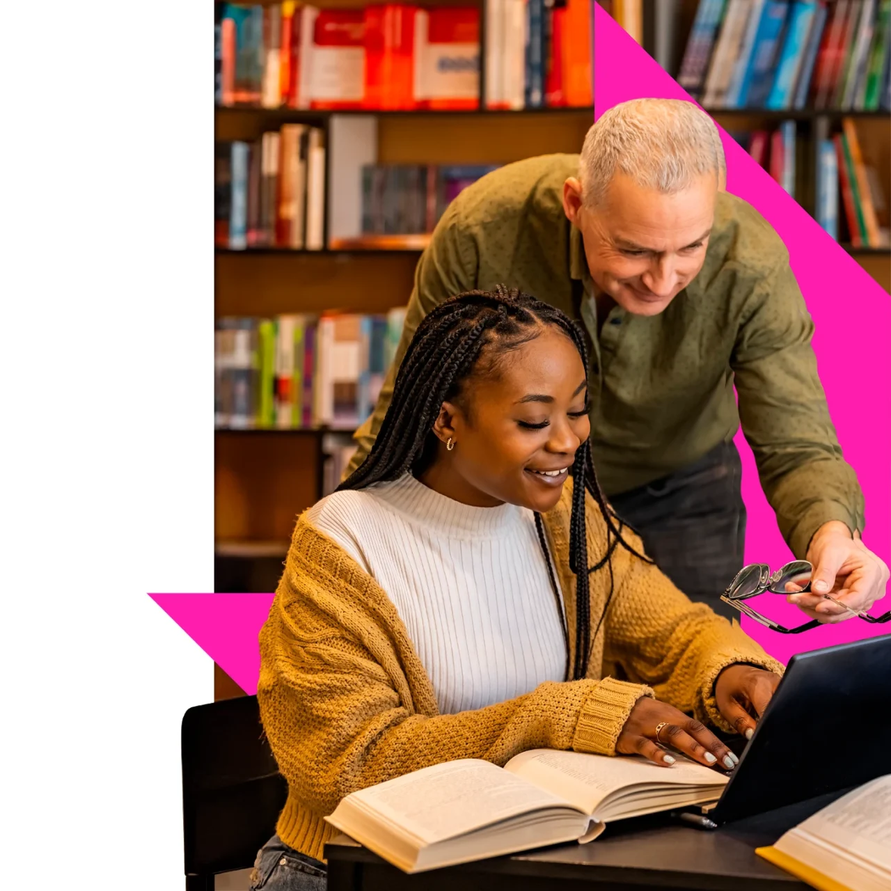 Two adults supporting a young person while reading together at a table