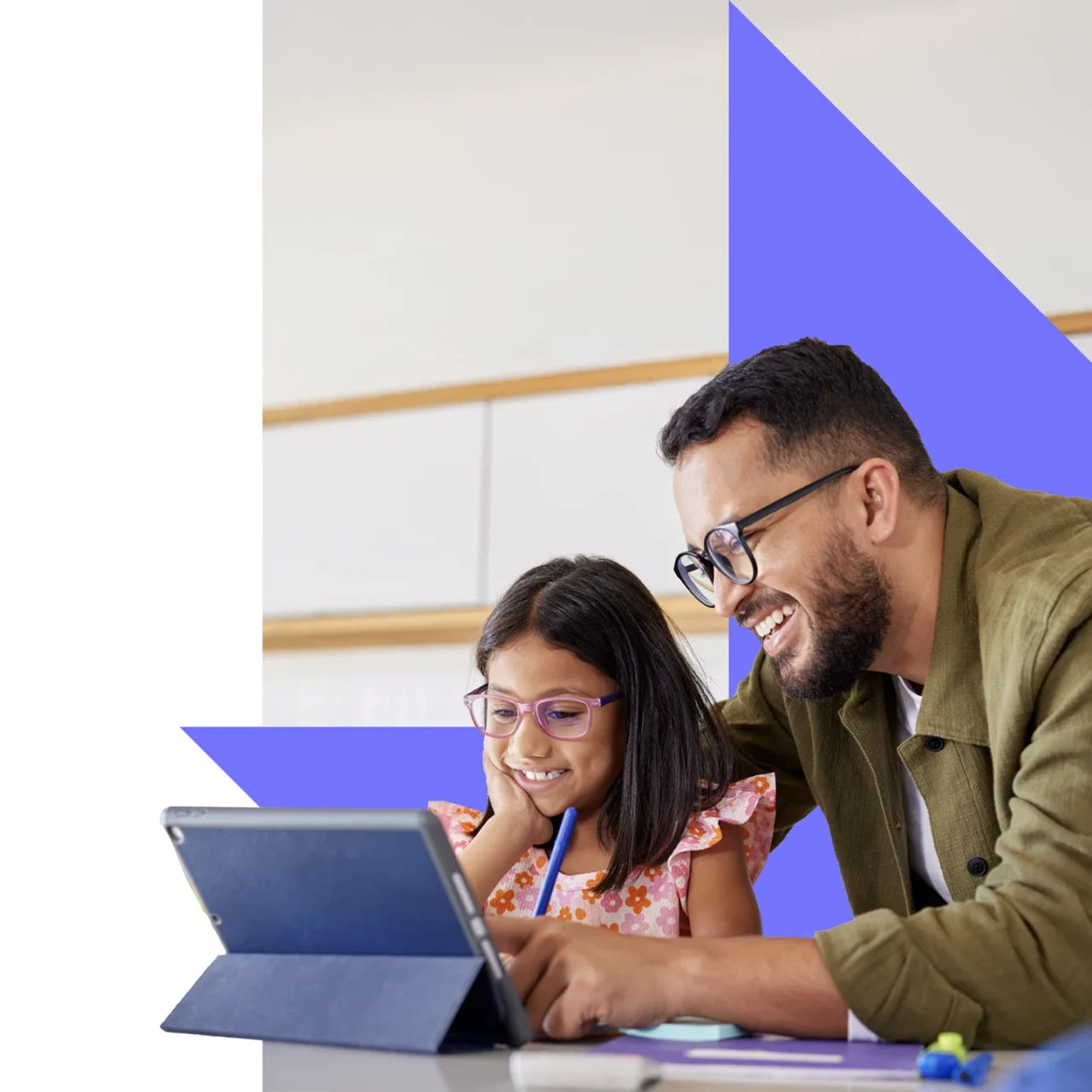 Adult and child sitting together and reading from a tablet