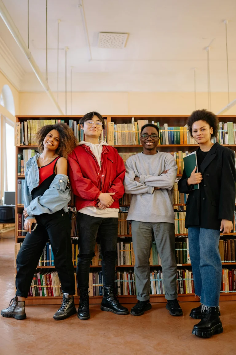 Group of young adults standing together in a library