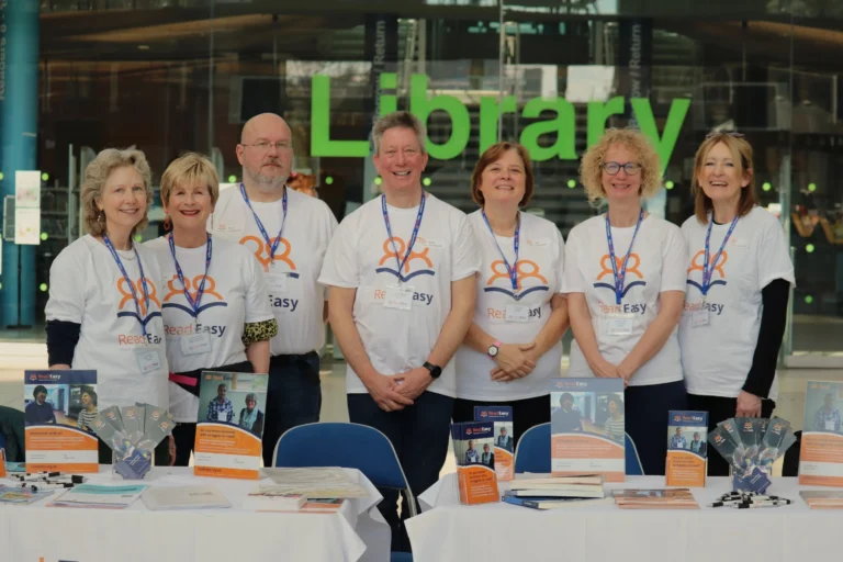 Group of volunteers standing together inside a library