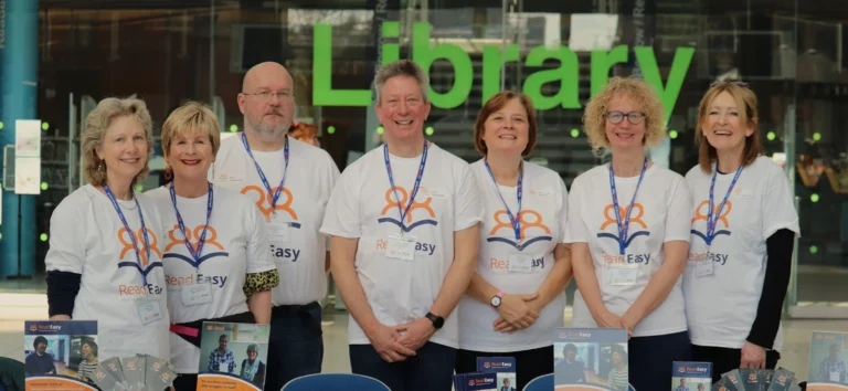 Group of volunteers standing together inside a library