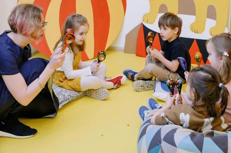 Children playing with colourful instruments.