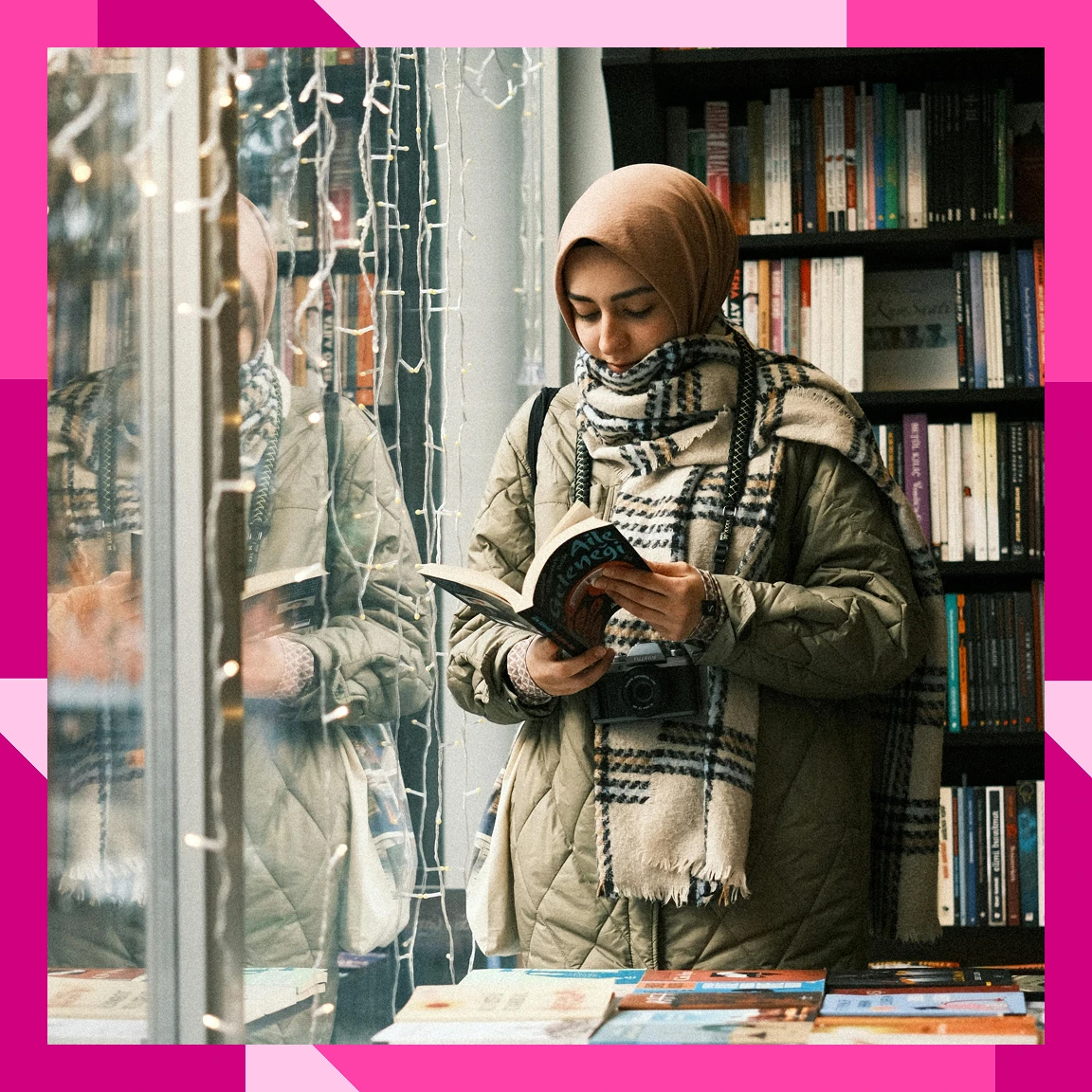 A woman reading a book from a display in a bookstore
