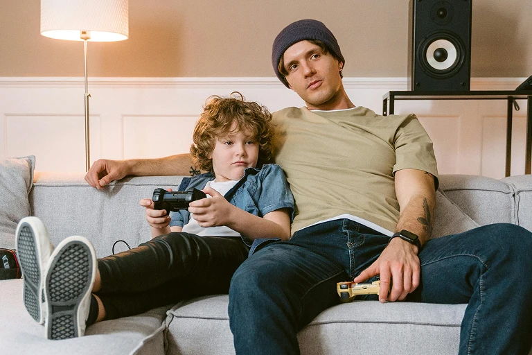 Father and son playing video games together