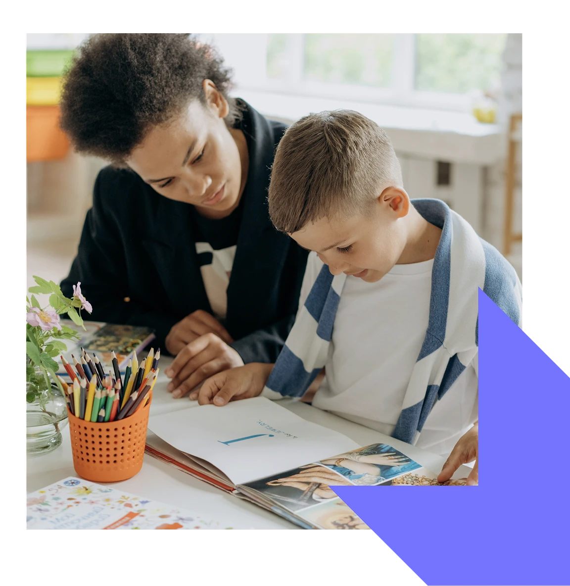 Caregiver helping young boy reading