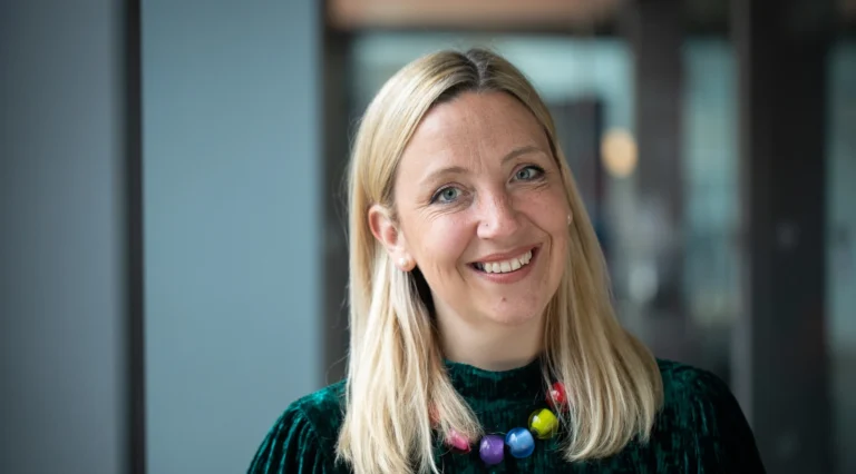 A woman smiling at the camera